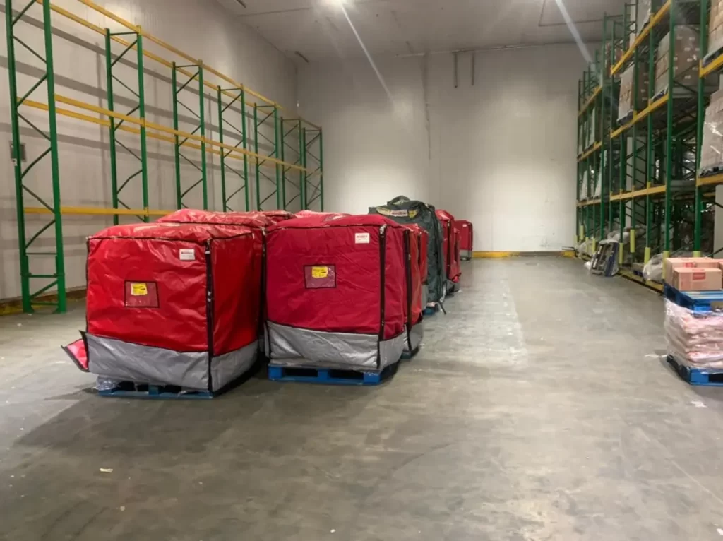 Reusable silver thermal pallet cover providing heat protection for palletised freight.